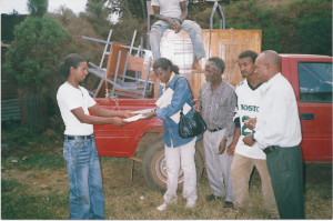 Ms. Terefech, chair person of the ENAD Jimma branch receiving furniture bought through the HAPCO project from Mr. Jebessa Yohannes, a deaf member who assembled the furniture, on 27 December 2005 (18 Tahsas 1998 E.C.)